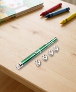 Emax green laser pointer with five caps in a real setting