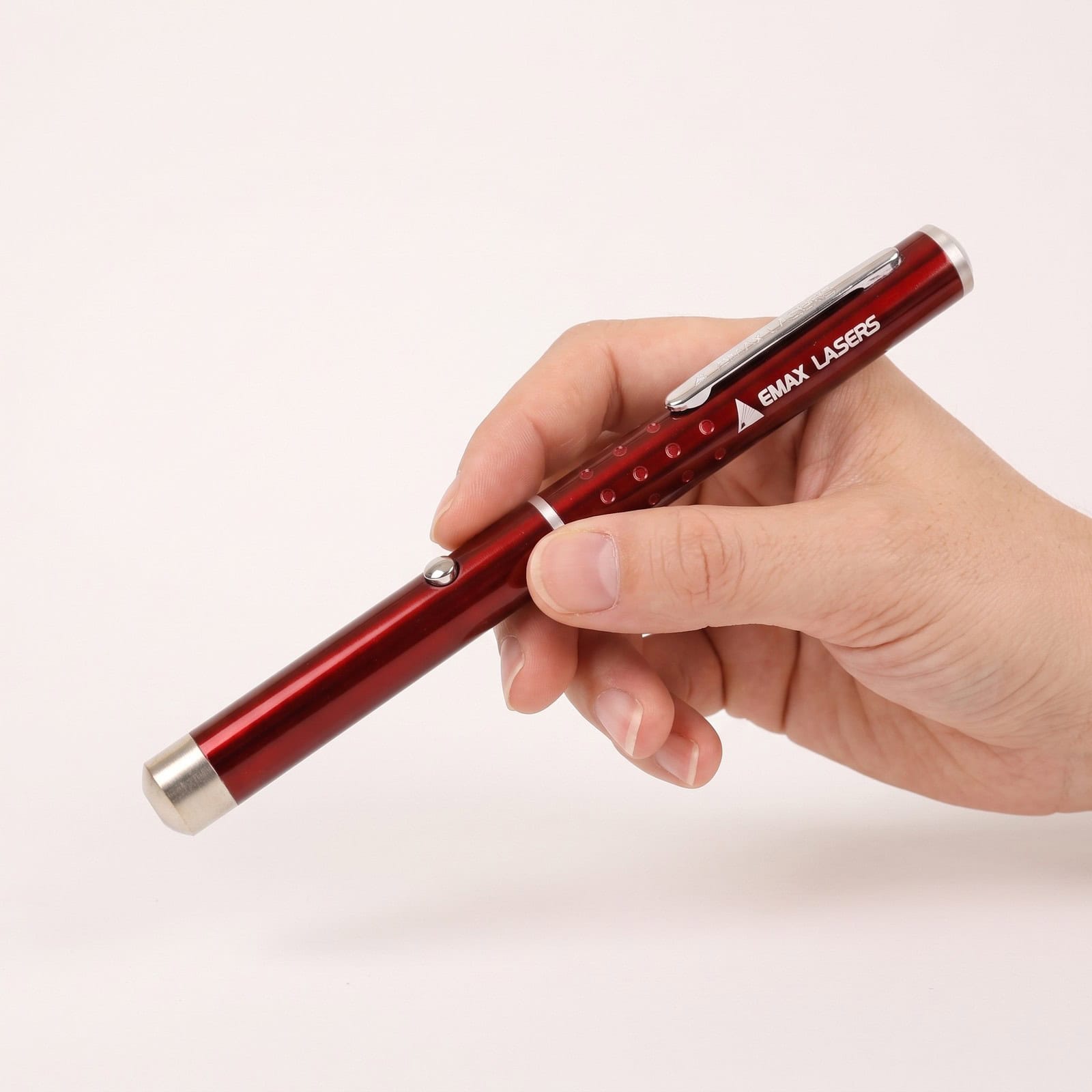 Emax red laser pointer held in the hand, to show the size