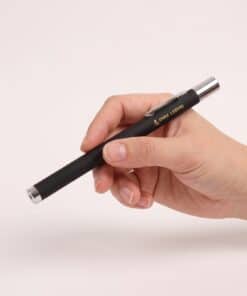 Emax red laser pointer with on/off switch held in the hand, to show the size