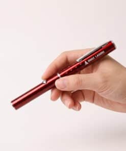 Emax red line laser held in the hand, to show the size